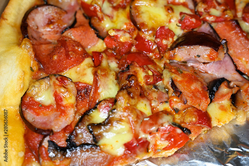 Sausage pizza with hot peppers in detail.