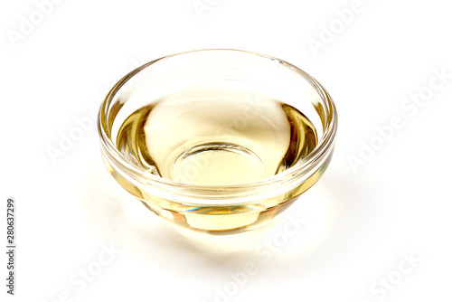 Apple vinegar in a glass bowl, isolated on white background photo