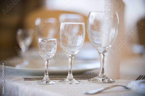 Light picture of empty glasses in restaurant - white plates