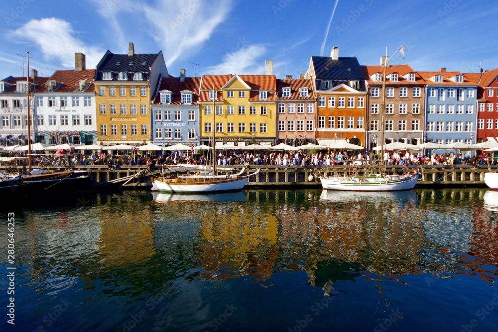 Colorful traditional houses of nyhavn reflected into the water canal in copenhagen denmark