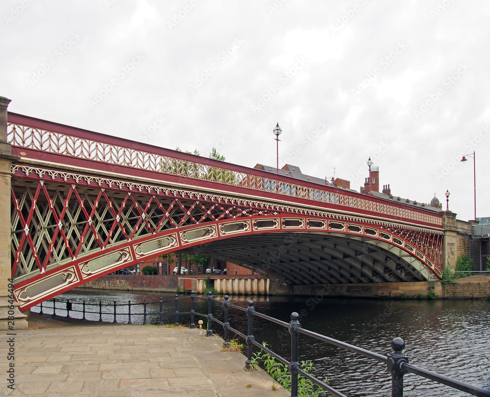 Naklejka premium crown point bridge crossing the river aire in leeds a single span fretted cast iron construction opened in 1842 taken from the riverside path
