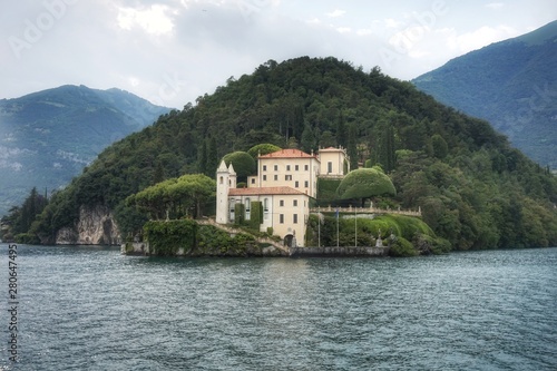 View of the Villa del Balbianello in the city of Lenno in the rays of the setting sun.