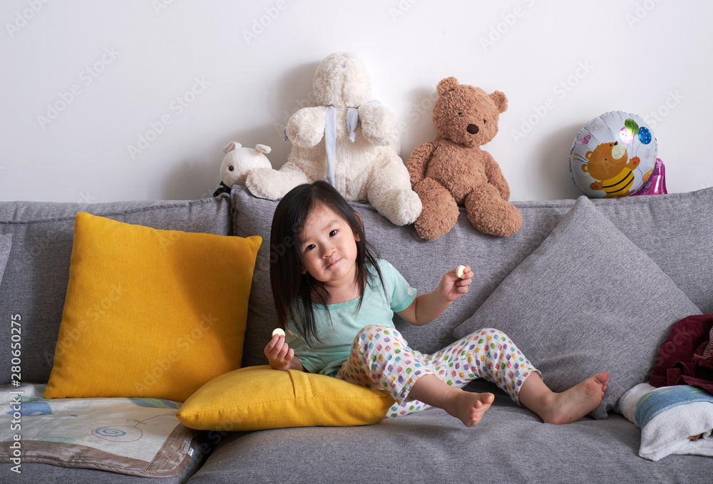 Asian children playing on the sofa at home Asian children playing on the sofa at home