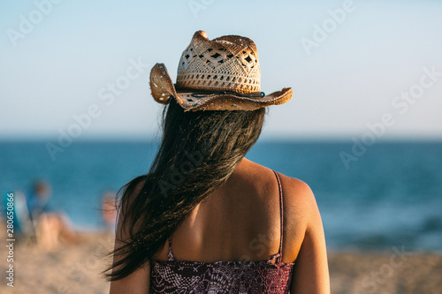 Woman on the beach looking at the sea photo