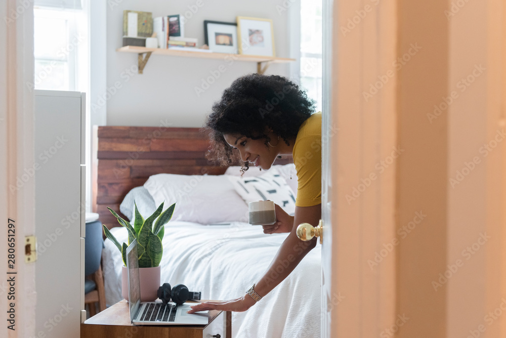 Woman checking her e-mail during morning routine Woman checking her e-mail during morning routine