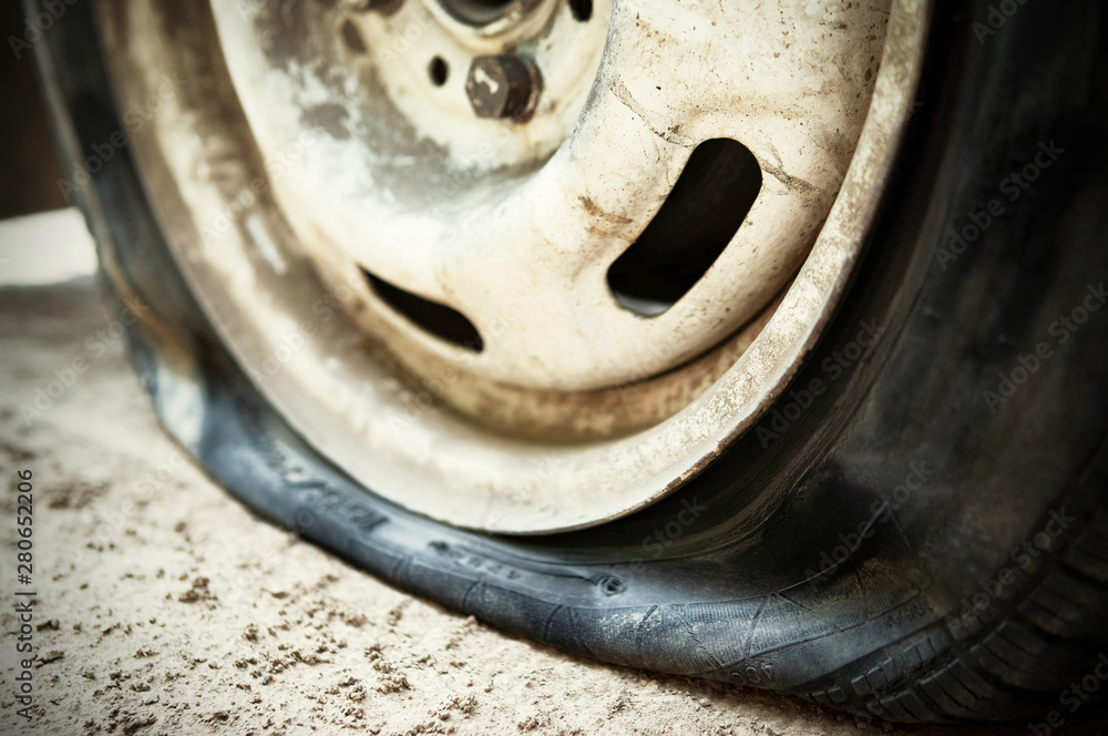 Flat tire. Punched wheel on a car. Close-up Flat tire. Punched wheel on a car. Close-up