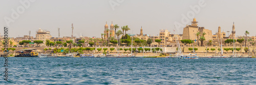 Karnak temple and the Muslim mosque on the banks of the river Nile in Luxor, Egypt
