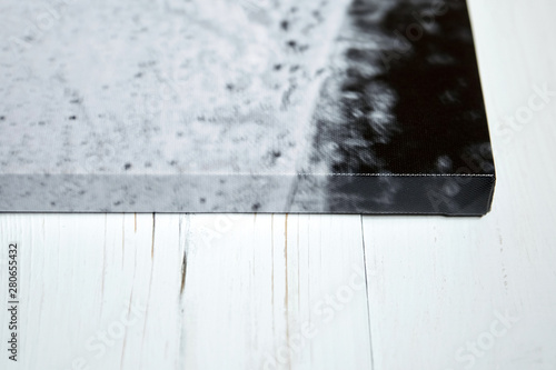 Photo canvas print. Sample of stretched photography with gallery wrapping on a wooden frame (stretcher bar). Lateral side view, closeup. Selective focus photo