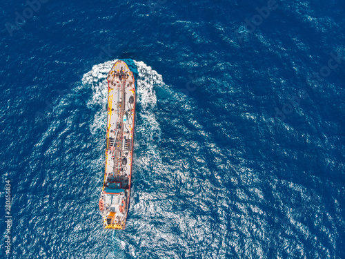 Oil chemical tanker sails blue sea. Aerial top view photo