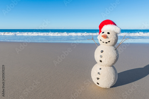 Christmas Sandy Snowman on a beautiful sand beach - Christmas symbol of countries where the weather is always warm