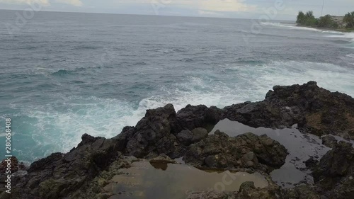 Aerial view of big footprint in seashore rocks photo