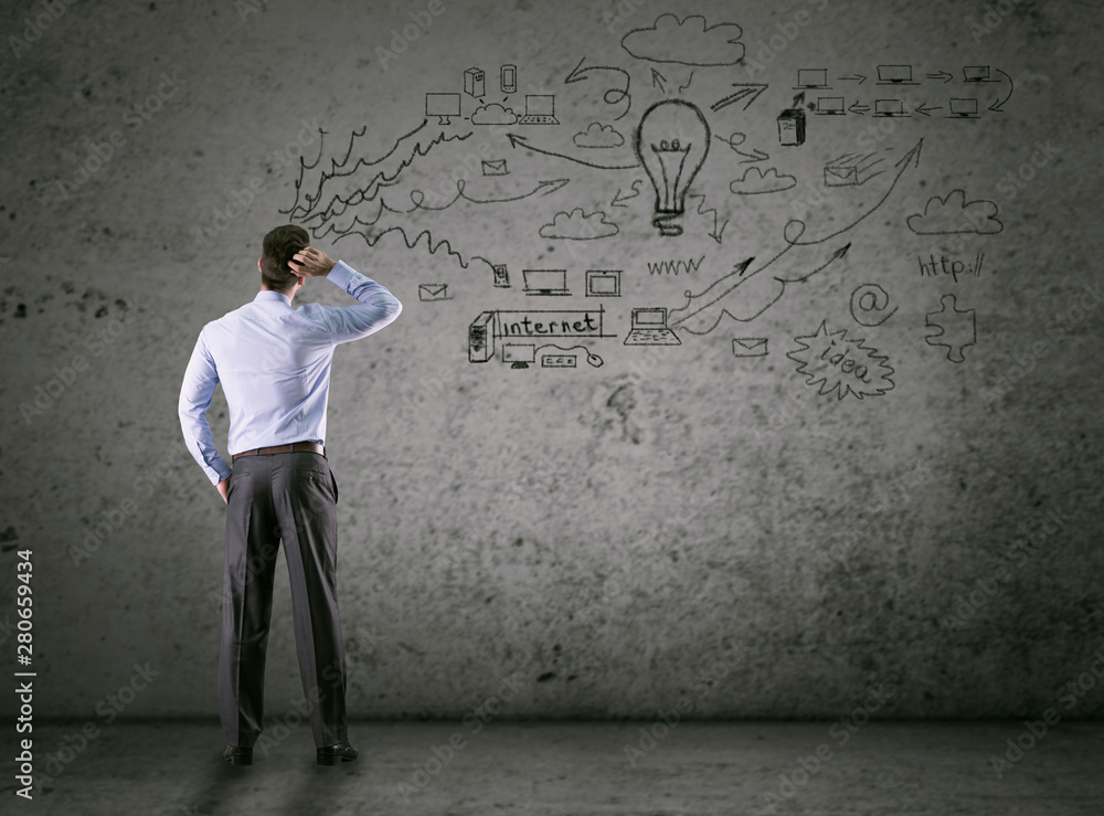 .business concept, thinking man looking at drawing wall .business concept, thinking man looking at drawing wall