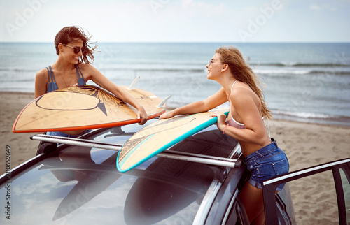 Photography girls ready to surf at the beach.