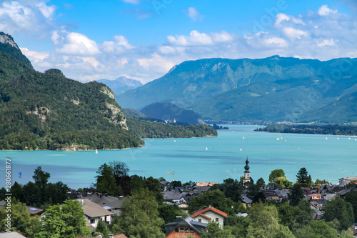 Landscape scenic view on Wolfgangsee lake in Salzkammergut, Austria from a high vantage point. Scenery of St. Gilgen with Alps clear blue water lake amongst mountains during Summer.