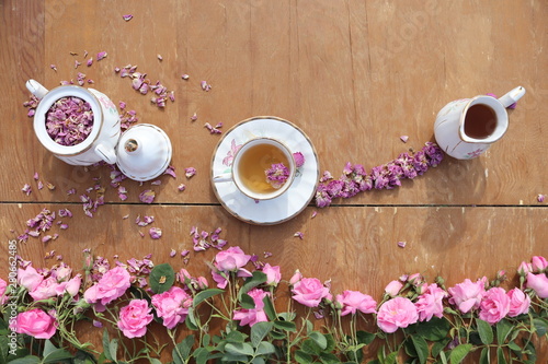 cup of coffee and flowers on wooden table