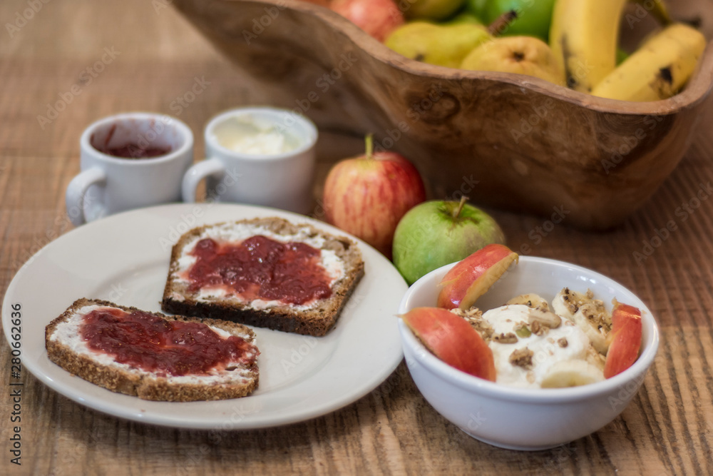 Healthy toasts with cream cheese, jelly and homemade yogurt with cereals Healthy toasts with cream cheese, jelly and homemade yogurt with cereals