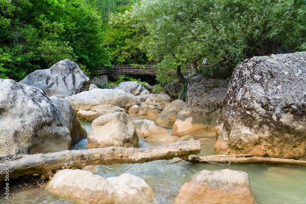 Naklejka premium Stone formation near Ilica waterfalls and wooden bridge in background, Pinarbasi, Kastamonu/Turkey