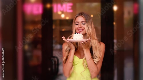 Beautiful girl drinks coffee with dessert in a cafe. advertising space