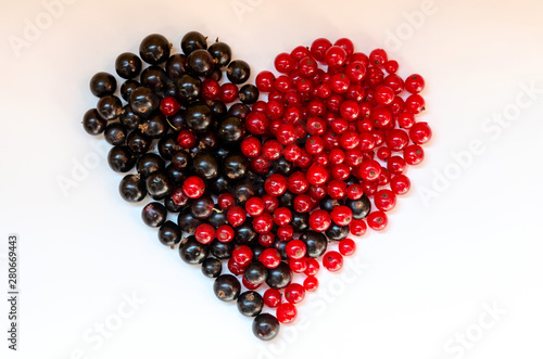Heart shape assorted berry fruits on white background. Black-blue and red food. Mixed berries with copy space for text. Various fresh summer berries. Berries in heart shape isolateed on a white.