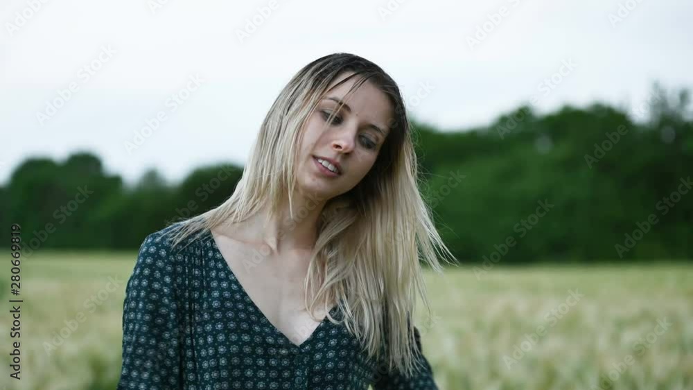 Portrait of a happy attractive Caucasian blonde girl with wet hair during a rain on the nature outdoor on a wheat field. Happiness hope flirting and coquetry Portrait of a happy attractive Caucasian blonde girl with wet hair during a rain on the nature outdoor on a wheat field. Happiness hope flirting and coquetry