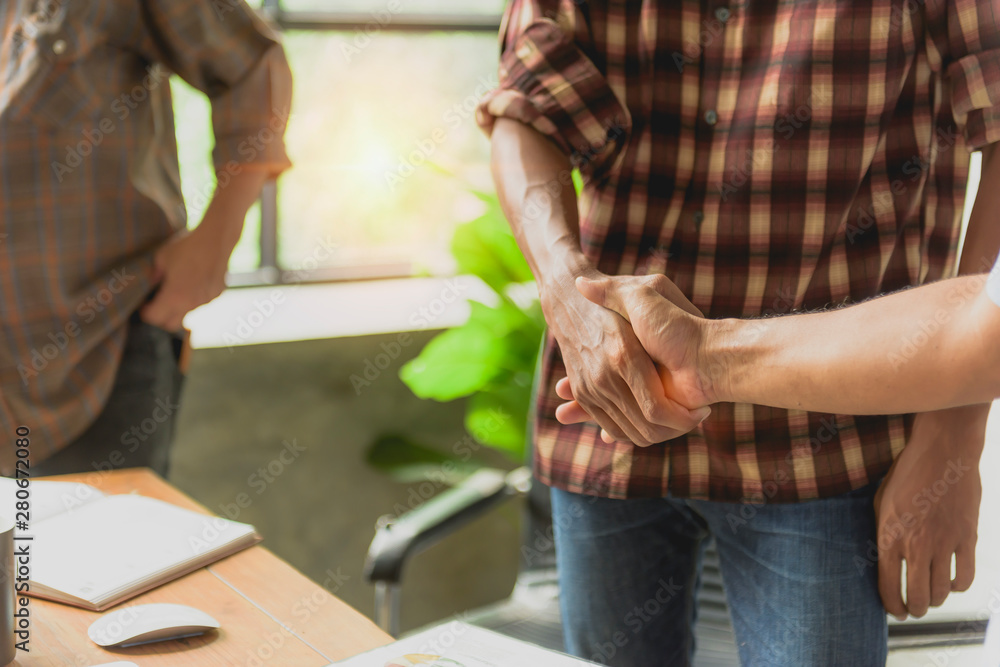 Obraz premium Business handshake executives to congratulate the join business agreement.concept for architect or engineer contract for architectural project.Stressed with partner and engineering tools on workplace