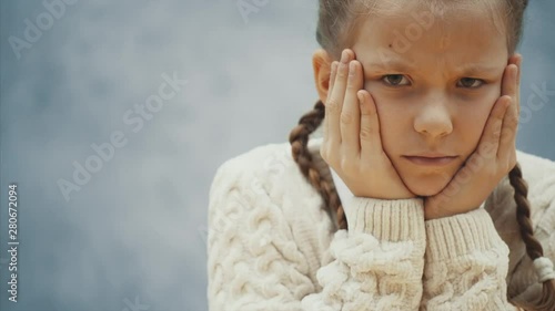 Little bored and a little bit angry schoolgirl doesn't want to learn anymore.