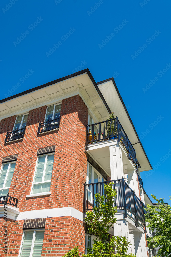 The corner of brand new apartment building on blue sky background The corner of brand new apartment building on blue sky background