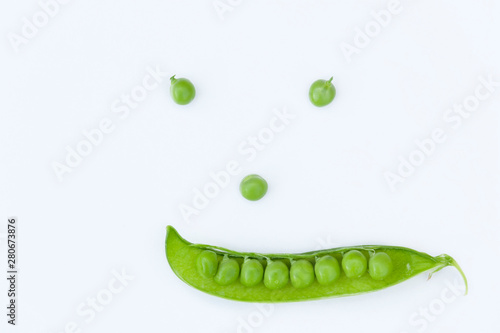 smile made of green peas as background