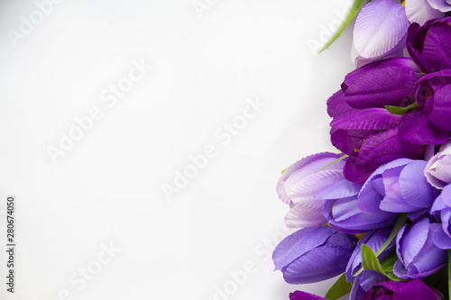 Fototapeta Naklejka Na Ścianę i Meble -  Closeup of artificial purple and violet flowers on a white background.