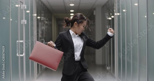 Wallpaper Mural Close up shot of successful businesswoman doing victory dance. Young asian manager celebrating her achievement in office hall with dance break - way to success concept 4k Torontodigital.ca