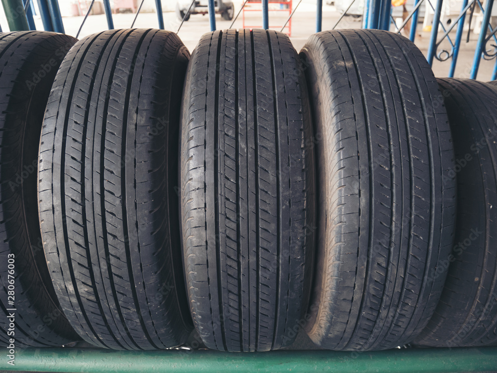 Tire rubber products , Group of new tires for sale at a tire store Tire rubber products , Group of new tires for sale at a tire store