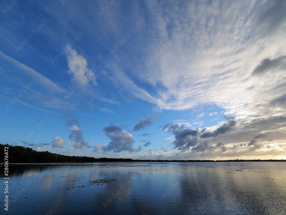 Sunset cloudscape and reflections on Coot Bay in Everglades National Park, Florida on a calm winter evening.