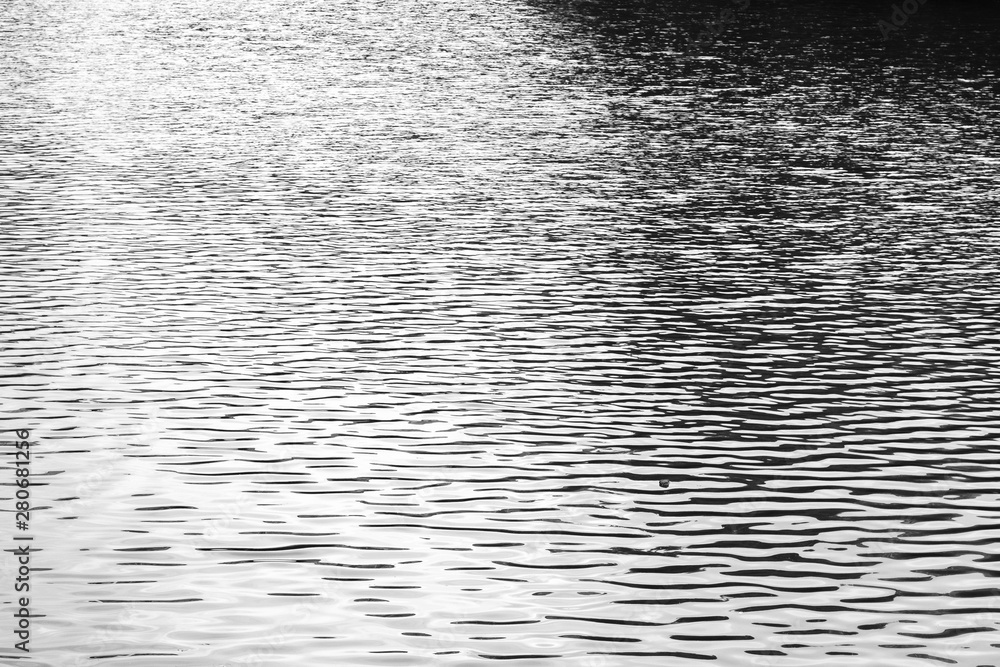 Black and white photo water texture. Small ripples from the wind on the water Black and white photo water texture. Small ripples from the wind on the water
