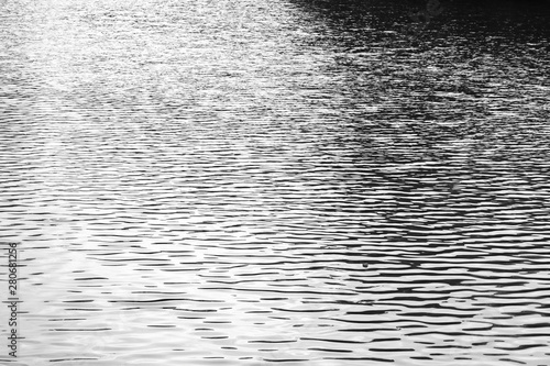 Black and white photo water texture. Small ripples from the wind on the water © OlgaKorica
