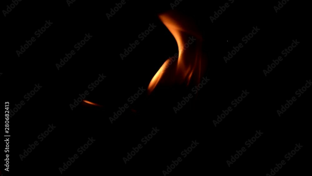 bright red yellow flames of fire in the dark. black background bright red yellow flames of fire in the dark. black background