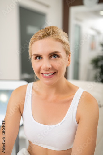 Smiling woman waiting for her spa procedures.