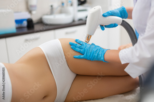 Woman with slim body lying in a beauty salon.