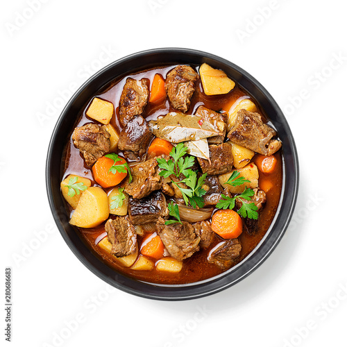 Beef meat  stewed with potatoes, carrots and spices (hungarian goulash). isolated on white background. photo