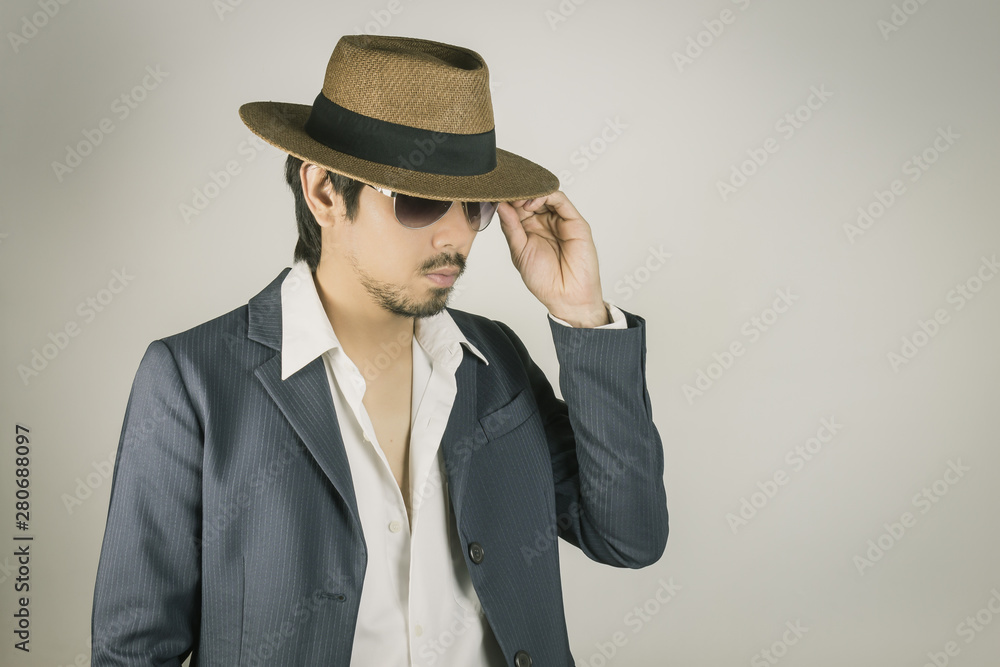 Portrait Man in Navy Blue Suit and Hat Touch Glasses Fashion on Side View Vintage Tone Portrait Man in Navy Blue Suit and Hat Touch Glasses Fashion on Side View Vintage Tone
