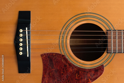 Fotografie close macro view of the six frets  and sound hole on an acoustic wooden  guitar