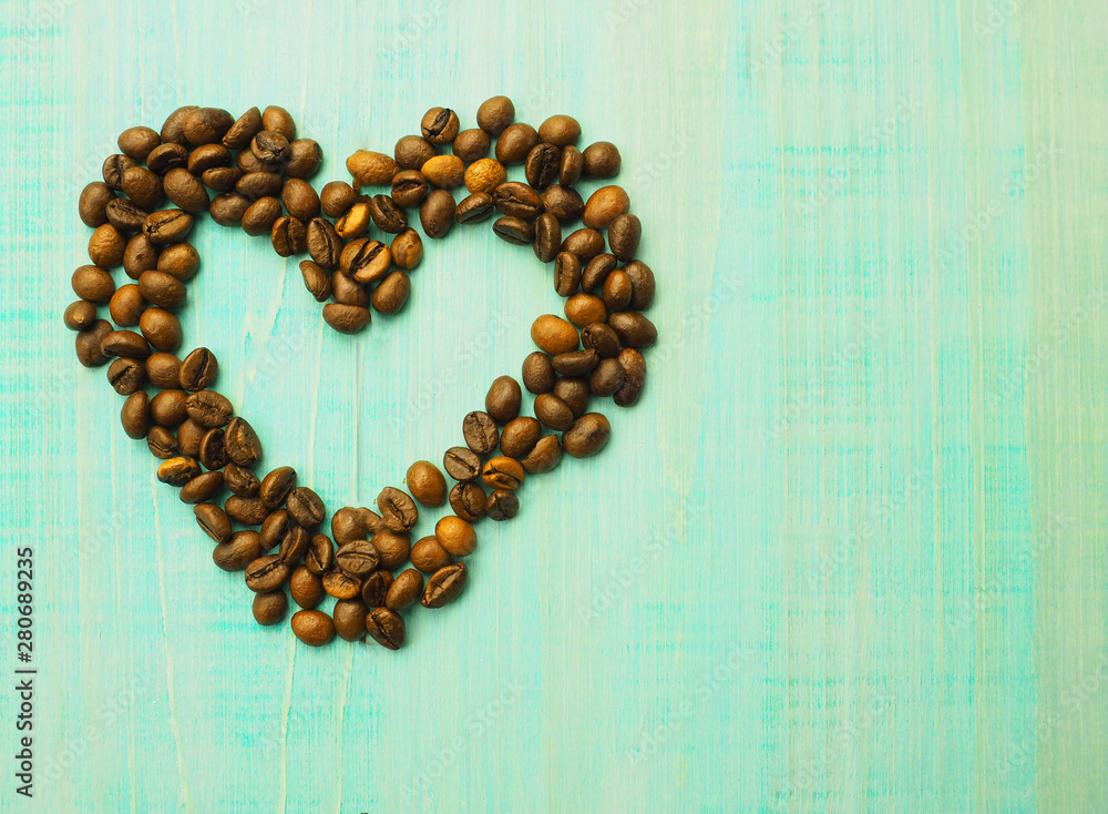 Heart shape made from coffee beans on wooden surface. Heart shape made from coffee beans on wooden surface.