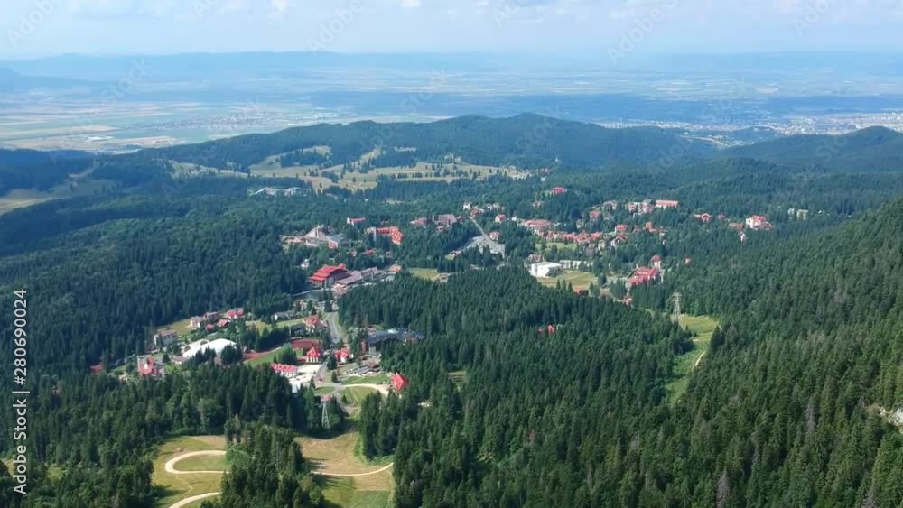 Poiana Brasov , luxury ski resort in the Carpathian Mountains , Romania, aerial drone footage from the Postavaru massif and the Transylvania plateau in the background. Poiana Brasov , luxury ski resort in the Carpathian Mountains , Romania, aerial drone footage from the Postavaru massif and the Transylvania plateau in the background.