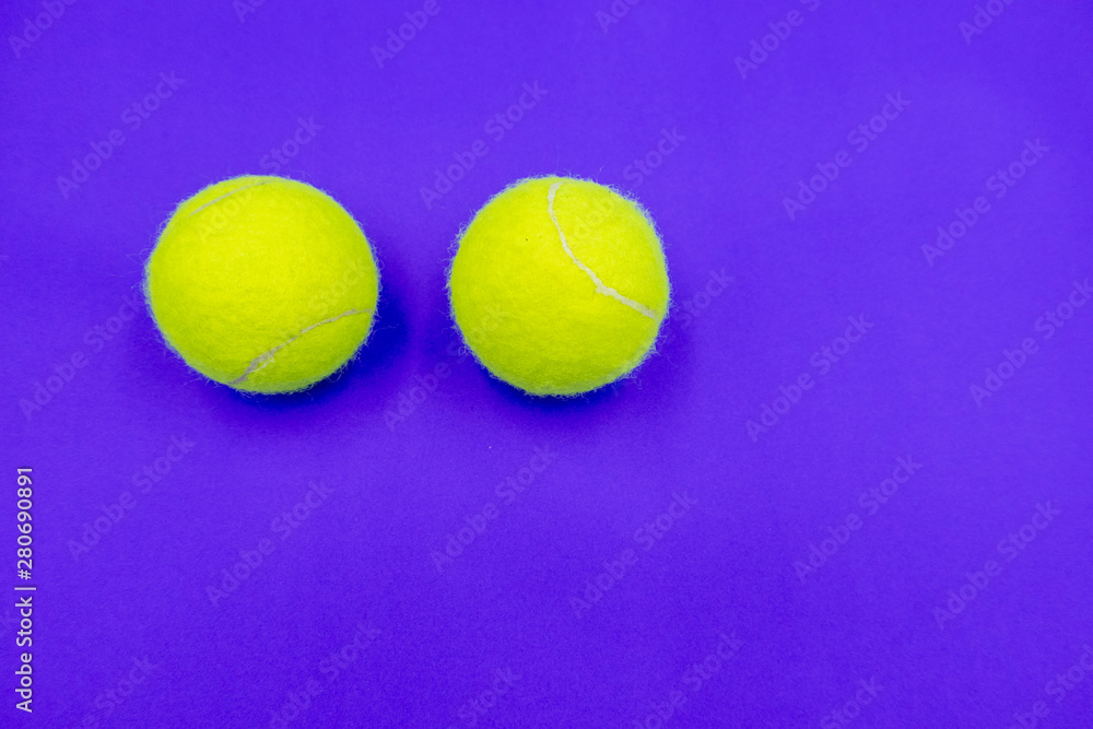 Tennis ball on purple background