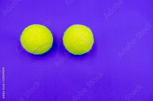 Tennis ball on purple background © thaninee