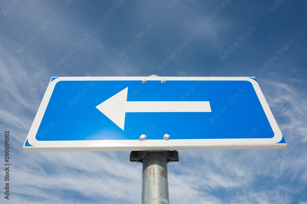 traffic sign arrow pointing left against sky traffic sign arrow pointing left against sky
