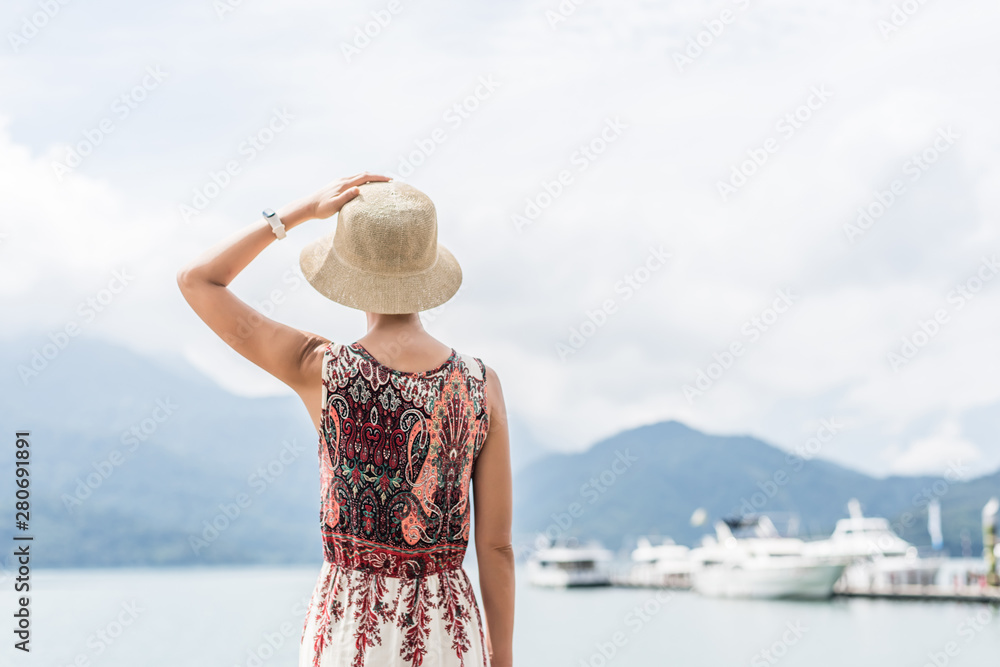 traveling Asian woman with hat