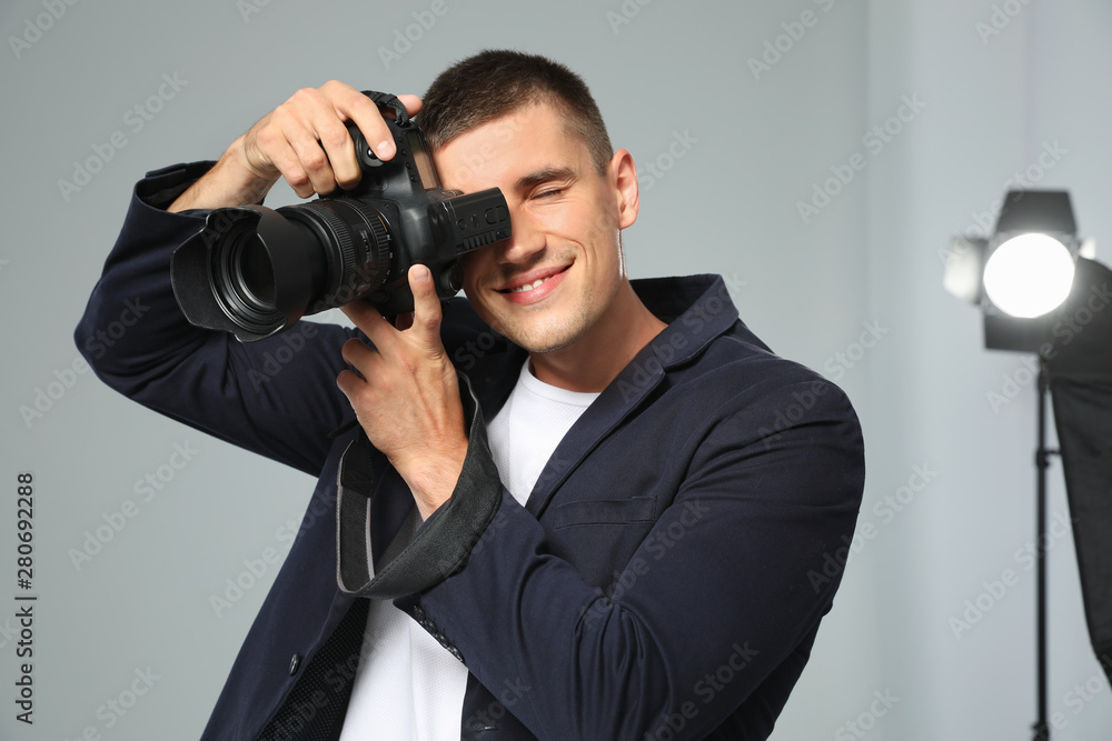 Professional photographer taking picture in modern studio Professional photographer taking picture in modern studio