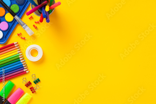 Fotografie School supplies on yellow background. Back to school concept..
