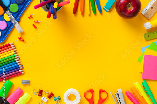 Fotografie School supplies on yellow background. Back to school concept..