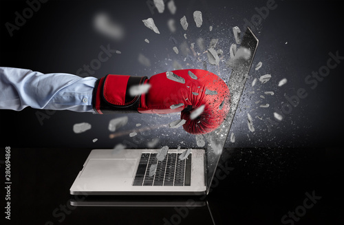 Strong male hand breaks laptop screen © ra2 studio